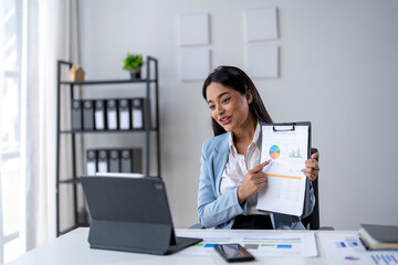 A woman is pointing at a graph on a presentation slide