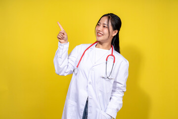 A woman in a white lab coat points to the camera