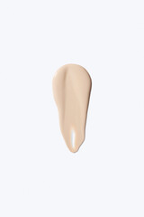 Liquid foundation smudge on white background. Beauty skincare texture swipe swatch. Cosmetic makeup cream sample isolated on white