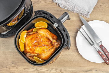 Roasted chicken from the hot air fryer oven. fast and easy crispy food with little or no fat by circulating hot air inside the basket