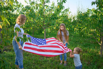  family on independence day picnic with american flag