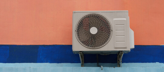 Air compressor or air condenser unit located on support outside building to heat released...
