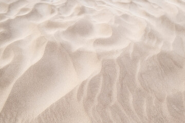 wind patterns on the sand of the beach, texture of a dune with waves made by the action of the wind, background