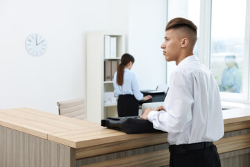 Professional receptionist and client in modern office