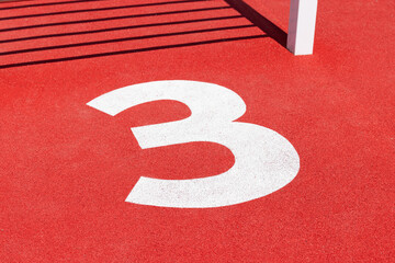 The number 3 on a sports floor. White on red. 3rd place / bronze medal concept