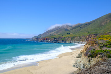 Majestic Coastal Cliffs Under Clear Blue Sky and Deep Blue Pacific Ocean