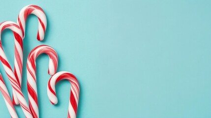 christmas candy canes on a blue isolated background with copy space for text. For banner, design, social media, blog, cover,card, wallpaper, thumbnail, youtube, etsy