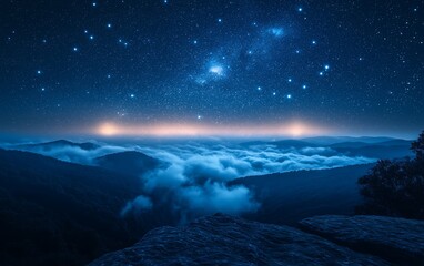 Naklejka premium A serene night landscape featuring mountains, clouds, and a starry sky.