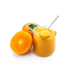 Persimmon purree in glass jar isolated on white
