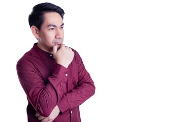 Asian Pensive man in a red shirt with a hand on his chin, gazing off into the distance. The image conveys a sense of contemplation and introspection against a clean white background.