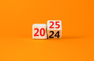 Business concept of 2025 new year symbol. Beautiful turned wooden cube and changed number 2024 to 2025. Beautiful orange table orange background, copy space. Business 2025 happy new year concept.