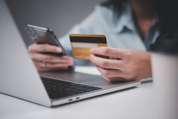 Businessperson using a smartphone and credit card for an online payment, representing secure digital transactions. Ideal for fintech services, ecommerce promotions, or online banking