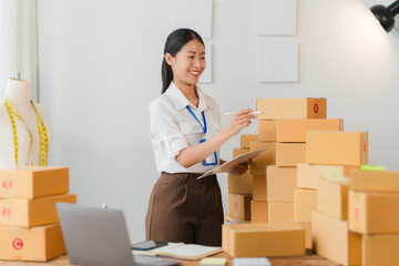 Entrepreneurial Spirit: A young woman confidently manages her small business, surrounded by stacked boxes, ready for shipment. This image evokes a sense of ambition, hard work, and the fulfillment of 