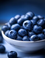 Extreme Close-Up of Plump, Fresh Blueberries Overflowing from a White Bowl, with Some Berries Spilling Over the Edge
