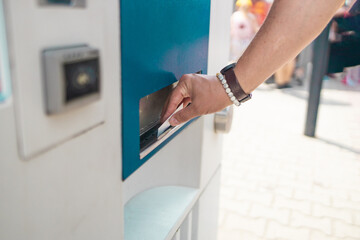 Naklejka premium Hipster businessman buying a ticket in a machine on subway station. High quality photo