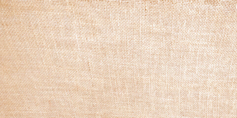 Fototapeta premium Close-up of fabric woven from burlap. Brown light linen texture or background for your design. close up of abstract fabric texture as background for interior design