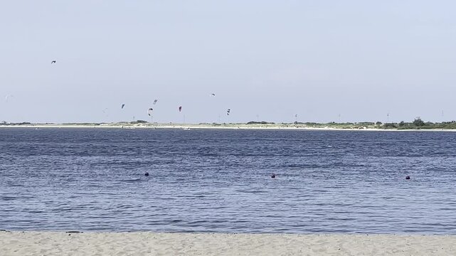 Highlands, New Jersey - August 18, 2024: Kite Surfers surf the waters between Sandy Hook and the Highlands as they take advantage of the weather provided by Hurricane Ernesto