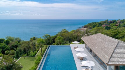 A beautiful beach with a pool and a house in the background