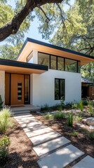 A contemporary house features a symmetrical front view with black windows and a concrete walkway leading to a vibrant grassy yard