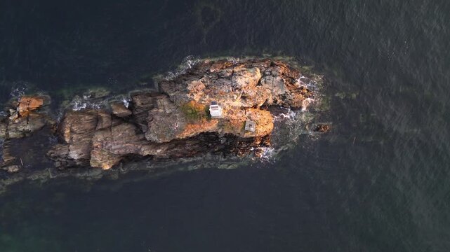 Top view by drone, of Cape Roger Curtis Lighthouse at Bowen Island at sunset in British Columbia