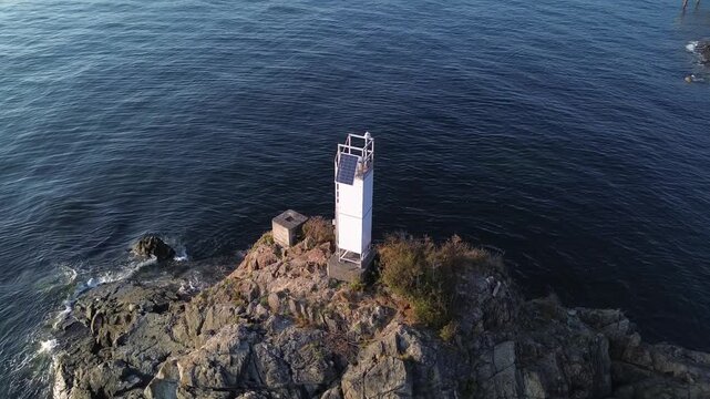 Drone view of Cape Roger Curtis Lighthouse at Bowen Island in British Columbia at sunset