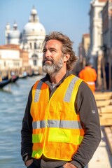 A contemplative moment by the canals of Venice with a worker in reflective gear