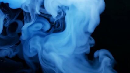 Blue smoke billows against a black background in creative visual display
