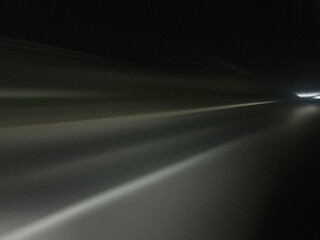 Gray light road trails, long time exposure motion blur effect. Night. Acceleration speed motion. Modern abstract high-speed light effect. 