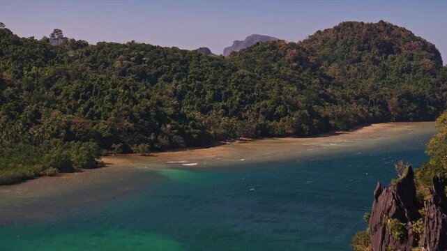 Establishing aerial view of tropical paradise exotic island surrounded by crystal blue sea and sail boats. Travel video of Bukal island El Nido Philippines, untouched nature on sunny summer day