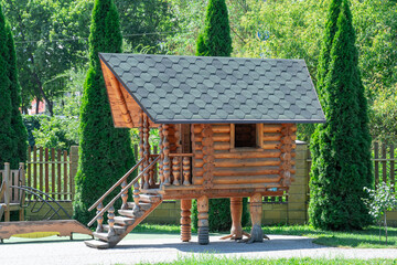 Wooden hut on chicken legs on playground. Fairytale character is house of baba yaga. Entertainment...