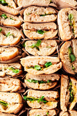 Delicious cafeteria sandwiches stacked on a tray