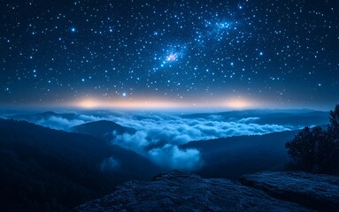 Fototapeta premium A serene night sky filled with stars over misty mountains and valleys.