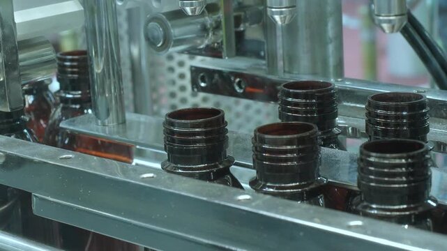 Bottles filling automation machine in modern factory. Technology demonstration of filling and capping bottles in the industry. Inspection of Vials For Defects. Pharmaceutical and drink Manufacturing.