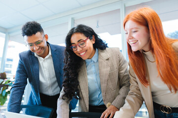 Close up of young smiling latin businesspeople team collaborating and doing business working in a...