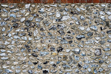 Flint and stone wall, exterior of building.