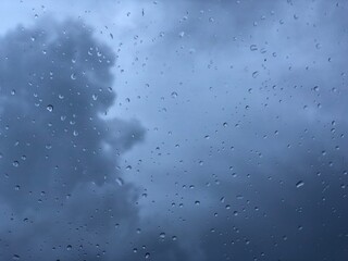 raindrops fall on a car windshield