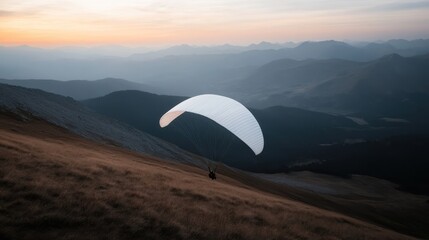 A white paraglider gracefully glides over a serene mountainous terrain during twilight hours, capturing a moment of solitude and peaceful reflection amidst nature's grandeur.