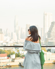 Bangkok, Thailand - 11th february, 2024:caucasian woman tourist enjoy shopping mall look out famous viewpoint over river in sunny hot day in southeast asia popular destination Bangkok city in Thailand