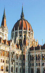 hungarian parliament building detail on clear sky morning with dome in the center 