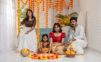 Onam celebration image Kerala teenage people making Onam pookalam and celebrating Onam festival