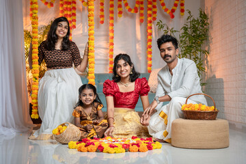 Onam festival background, South Indian people celebrating Onam festival by making Onam pookalam © sarath