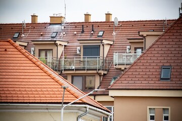 Balcony of an apartment among the roofs of houses. Architecture of Europe