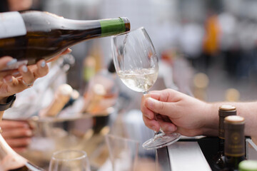 Adult holds up a glass  wine enjoying the pleasant weatherAdult holds up a glass  wine enjoying the pleasant weather