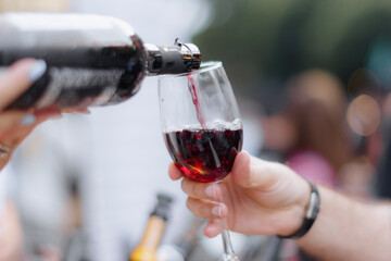 Elegantly serving red wine in a wine boutique