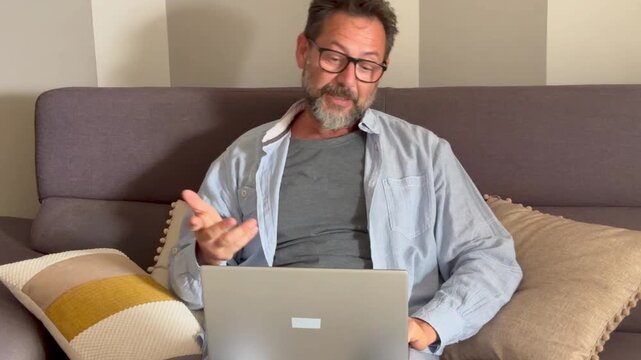 Man sit on desk in living room look at laptop screen start conversation use videocall app. E-employment, pass job interview remotely, business solutions via videoconference start up small business