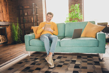 Obraz premium Full size photo of handsome mature man sit couch online study write notebook dressed yellow outfit cozy day light home interior living room