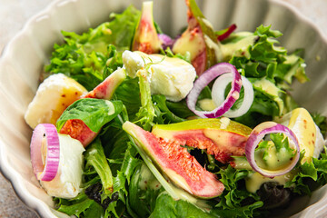 fig salad green lettuce, figs, soft cheese fresh meal food snack on the table copy space food background rustic top view keto or paleo diet vegetarian vegan food