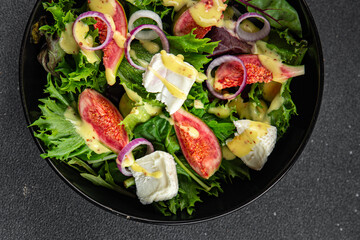 fig salad green lettuce, figs, soft cheese fresh meal food snack on the table copy space food background rustic top view keto or paleo diet vegetarian vegan food