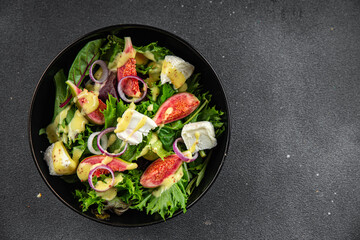 fig salad green lettuce, figs, soft cheese fresh meal food snack on the table copy space food background rustic top view keto or paleo diet vegetarian vegan food