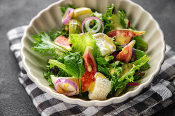 fig salad green lettuce, figs, soft cheese fresh meal food snack on the table copy space food background rustic top view keto or paleo diet vegetarian vegan food